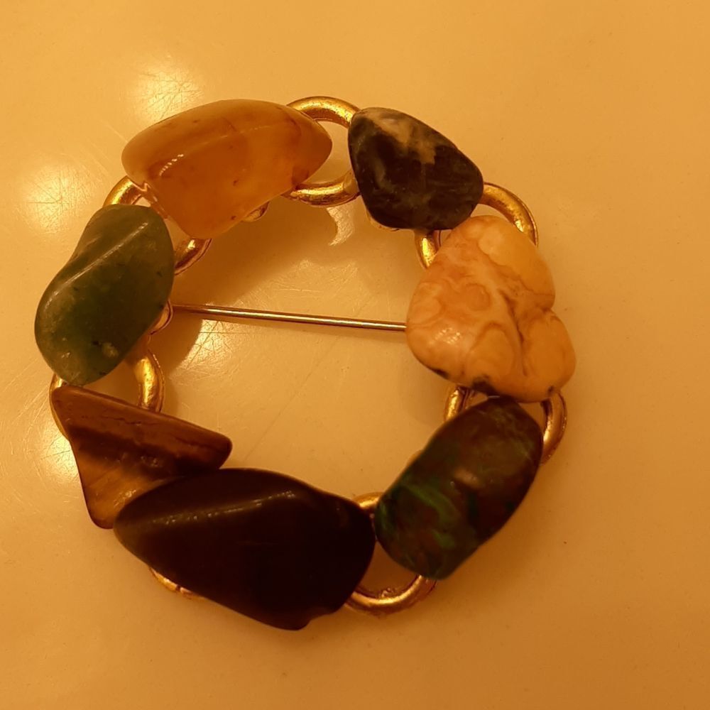 Vintage gold toned brooch with semi precious stones.